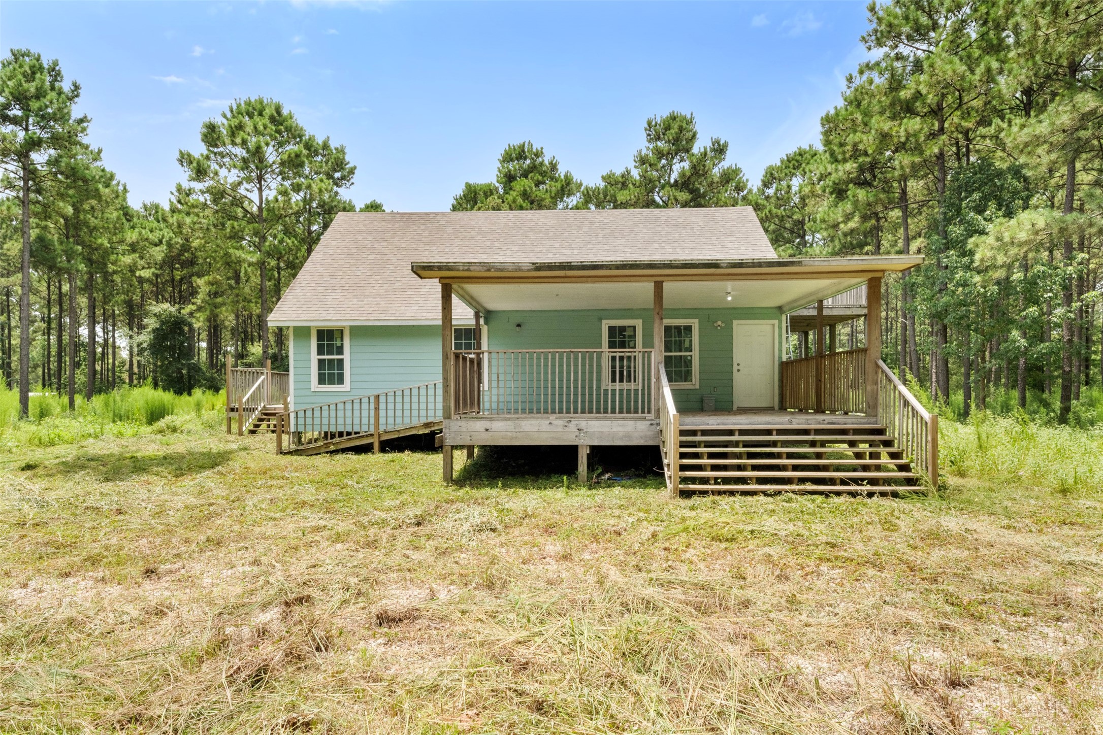 235 Bracewell Cemetery Road Livingston, TX 77351 - Photo 2 of 39 a front view of a house with a garden
