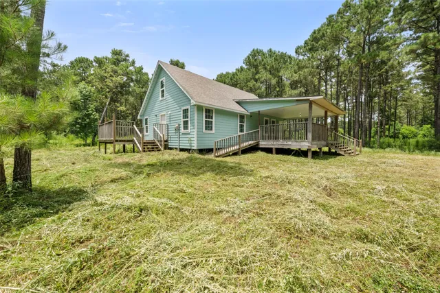 a view of a house with yard and sitting area