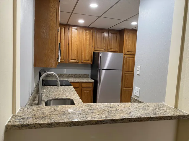 a kitchen with a refrigerator and a sink