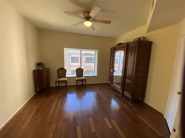 a view of a livingroom with furniture and hardwood floor