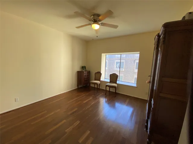 a view of a livingroom with a flat screen tv and wooden floor