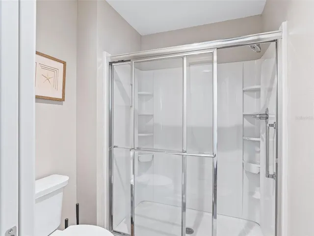 a bathroom with a shower and a toilet