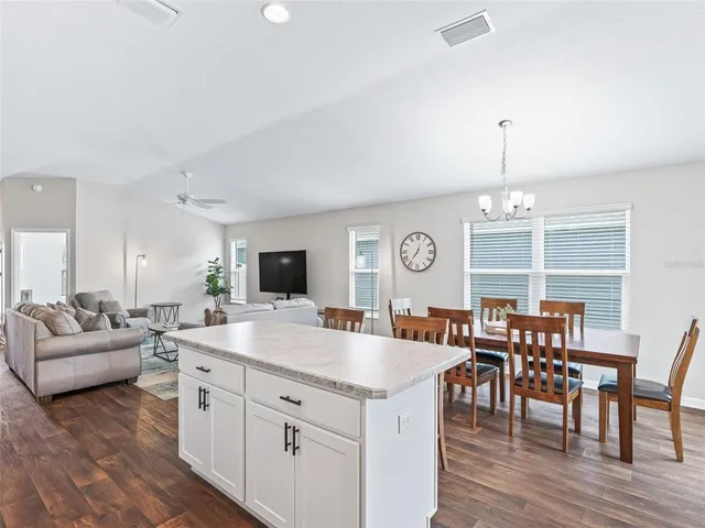 a view of dining table chairs and wooden floor