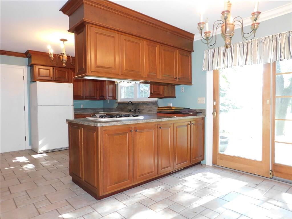 590 Methodist Road Greenville, PA 16125 - Photo 13 of 25 NATURAL LIGHT STREAMS THREW THE KITCHEN AND HIGHLIGHTS THE CHERRY CABINETS