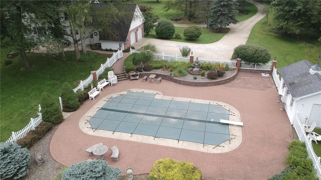 590 Methodist Road Greenville, PA 16125 - Photo 6 of 25 BRICK PATIO AND FENCING SURROUND THE IN GROUND POOL/POOL HOUSE FOR EASY STORAGE AND ACCESS/NICELY LANDSCAPED/