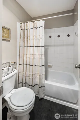 a bathroom with a sink a toilet and bathtub