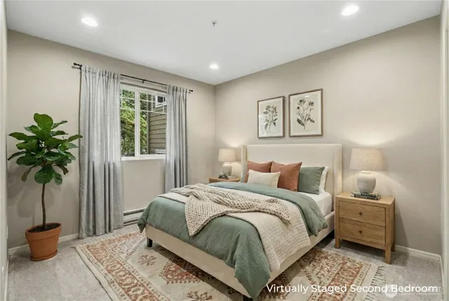 a bedroom with a bed and a potted plant