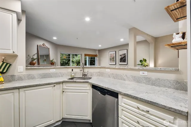 a kitchen with sink and mirror