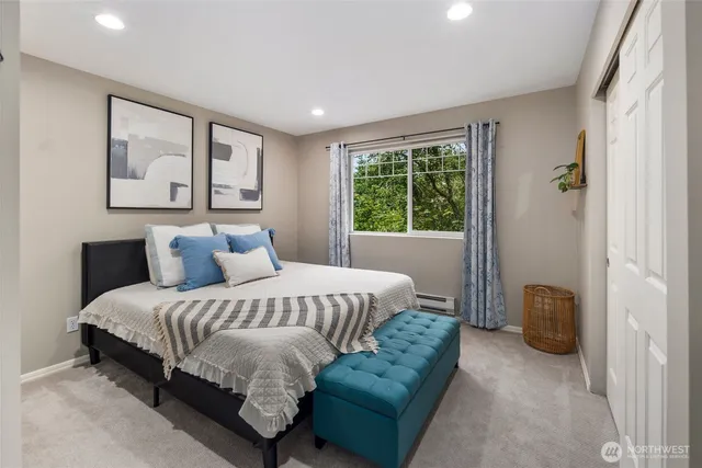 a spacious bedroom with a bed and a couch