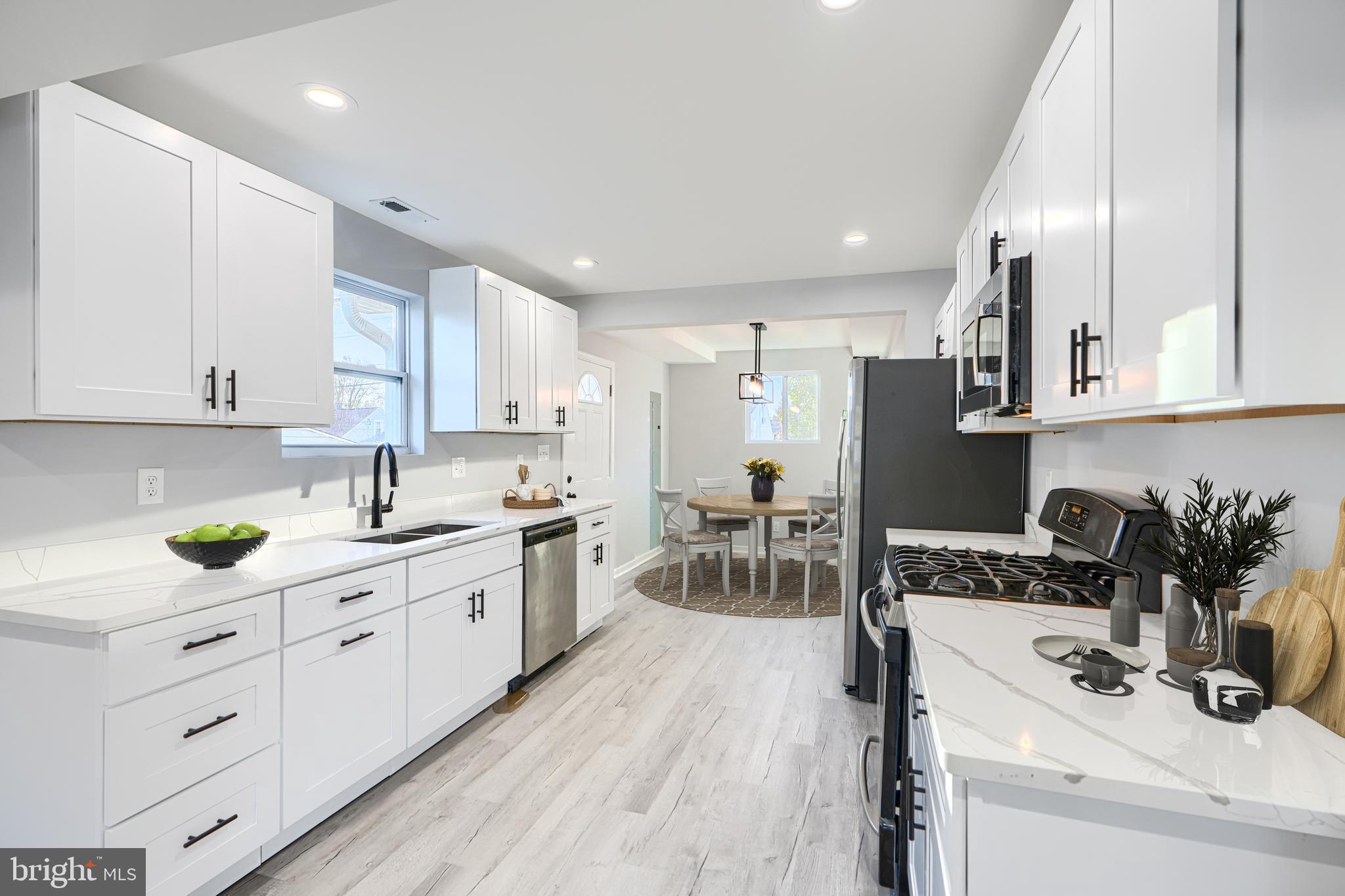 9 Avenal Road Baltimore, MD 21221 - Photo 6 of 30 a kitchen with white cabinets stainless steel appliances and sink