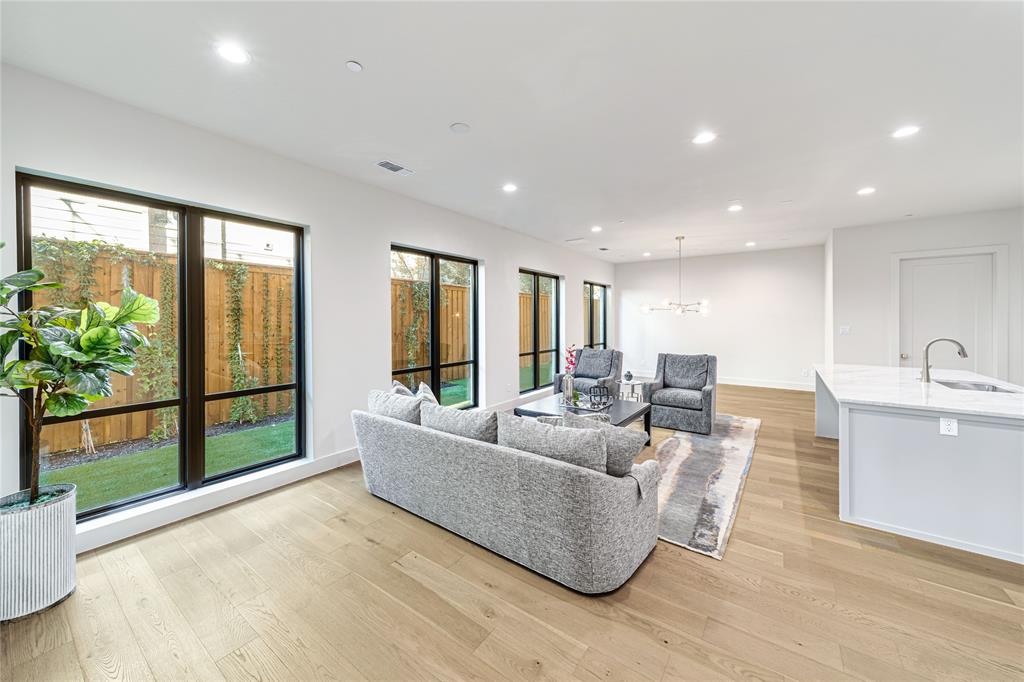 3601 Routh Street, Unit 1B Dallas, TX 75219 - Photo 1 of 22 a living room with furniture and a large window