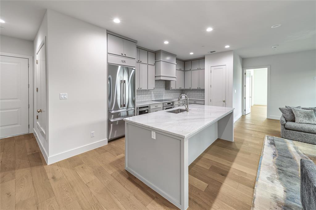 3601 Routh Street, Unit 1B Dallas, TX 75219 - Photo 11 of 22 a kitchen with a sink stainless steel appliances and counter space