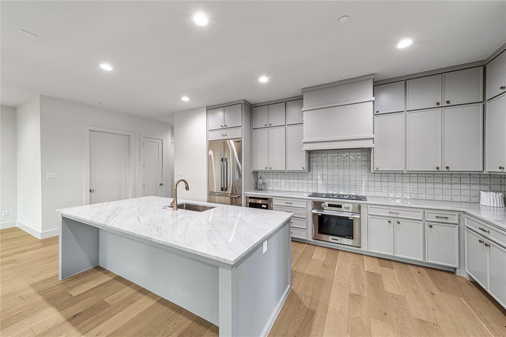 3601 Routh Street, Unit 1B Dallas, TX 75219 - Photo 13 of 22 a kitchen with a stove sink and cabinets