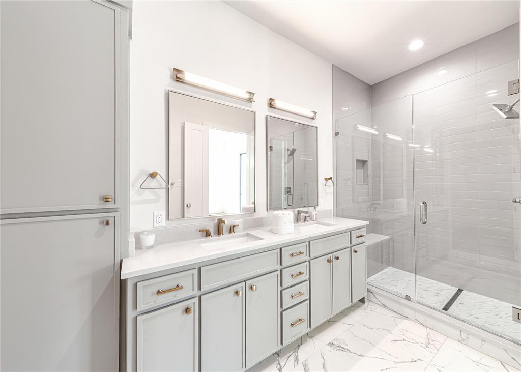 3601 Routh Street, Unit 1B Dallas, TX 75219 - Photo 17 of 22 a spacious bathroom with a shower sink and mirror