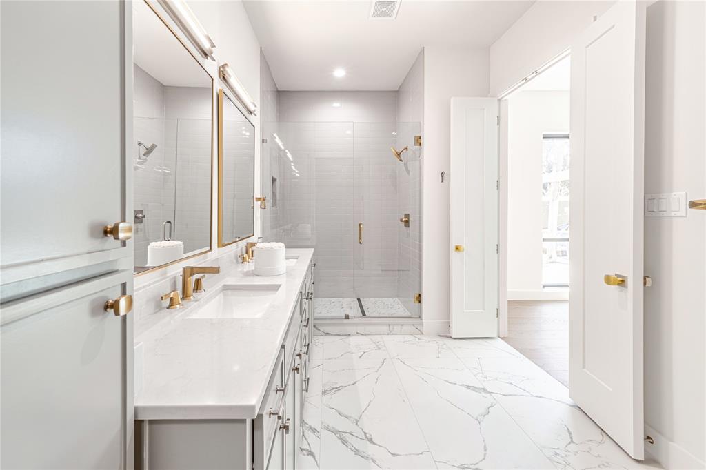 3601 Routh Street, Unit 1B Dallas, TX 75219 - Photo 18 of 22 a bathroom with a sink a toilet and shower