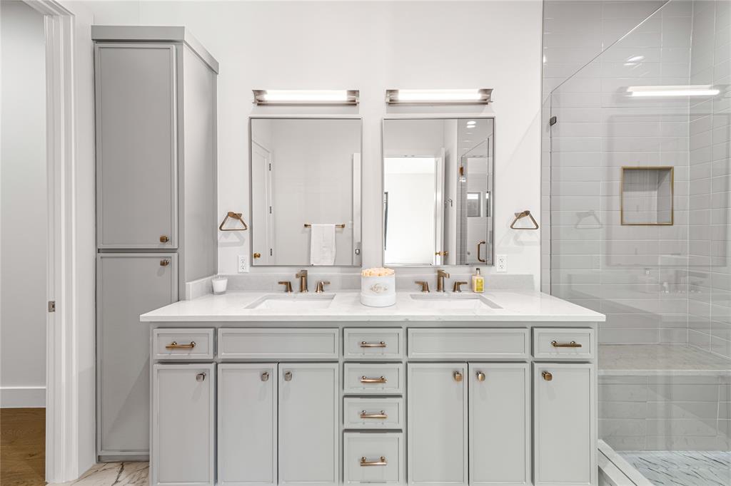 3601 Routh Street, Unit 1B Dallas, TX 75219 - Photo 19 of 22 a bathroom with a sink vanity and mirror