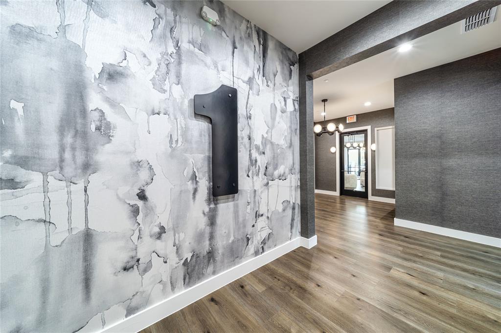 3601 Routh Street, Unit 1B Dallas, TX 75219 - Photo 20 of 22 a view of a hallway with wooden floor and staircase