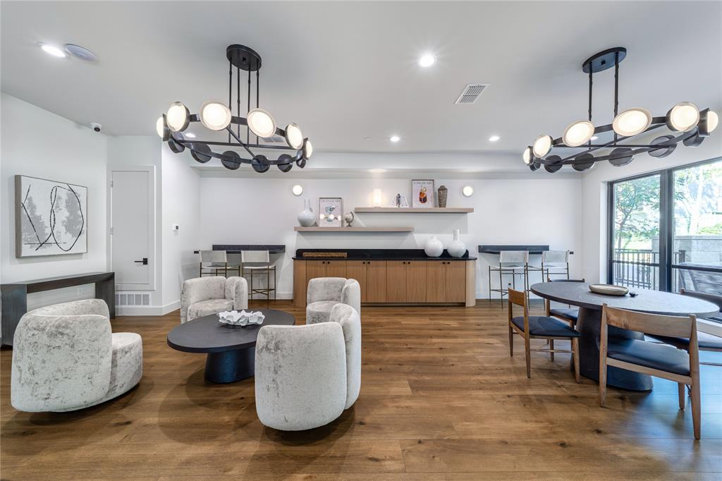 3601 Routh Street, Unit 1B Dallas, TX 75219 - Photo 21 of 22 a living room with furniture kitchen view and a chandelier