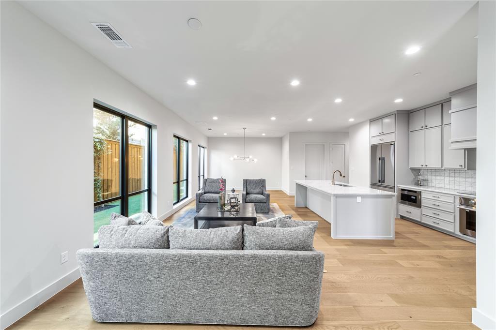 3601 Routh Street, Unit 1B Dallas, TX 75219 - Photo 4 of 22 a living room with furniture and large windows