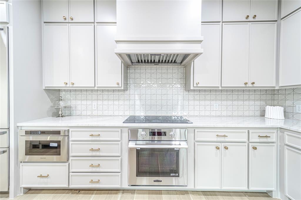 3601 Routh Street, Unit 1B Dallas, TX 75219 - Photo 6 of 22 a stove top oven sitting inside of a kitchen