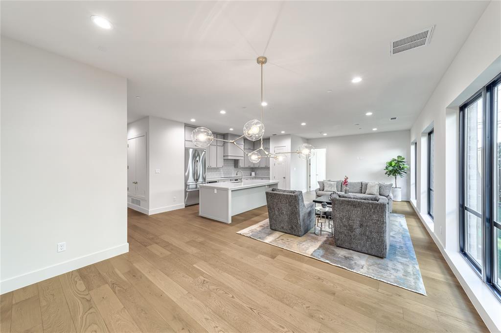 3601 Routh Street, Unit 1B Dallas, TX 75219 - Photo 10 of 22 a living room with stainless steel appliances kitchen island granite countertop furniture and a view of kitchen