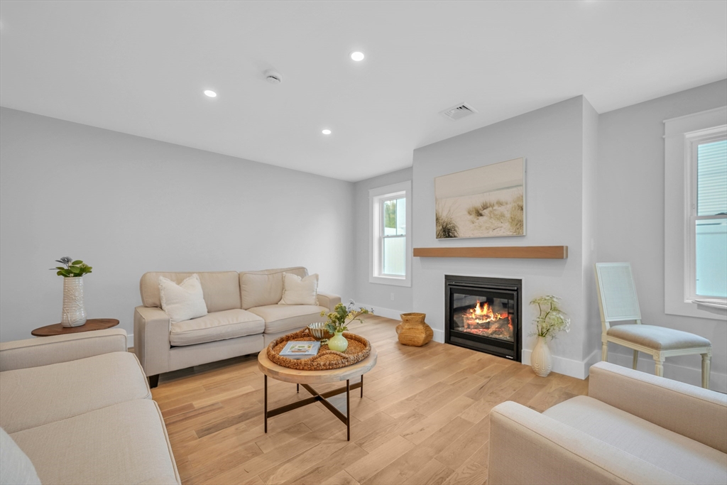 12 Hayes Street, Unit 1 Acushnet, MA 02743 - Photo 12 of 26 a living room with furniture and a fireplace