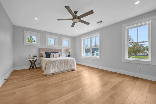 a bedroom with a large bed and a large window