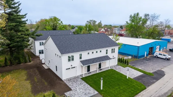 a aerial view of a house with a yard