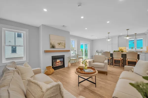 a living room with furniture fireplace and window