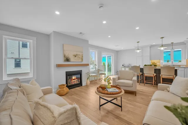 a living room with furniture fireplace and window