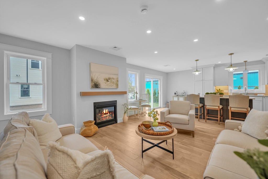 12 Hayes Street, Unit 1 Acushnet, MA 02743 - Photo 9 of 26 a living room with furniture fireplace and window