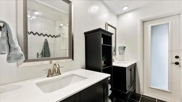 a bathroom with a sink vanity and a mirror