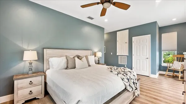 a bathroom with a granite countertop toilet a sink and a mirror