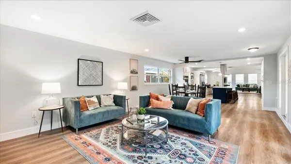 a living room with furniture and wooden floor