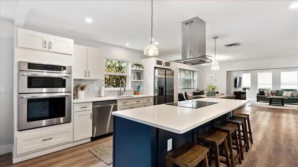 a kitchen with a stove a sink and a refrigerator