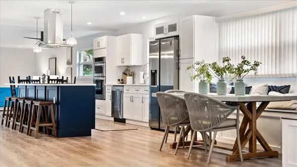 a dining room with furniture and a chandelier