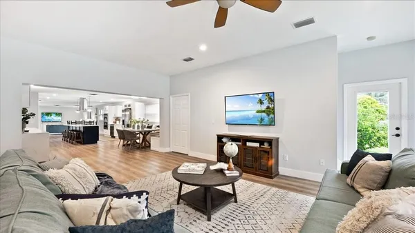 a living room with furniture and wooden floor