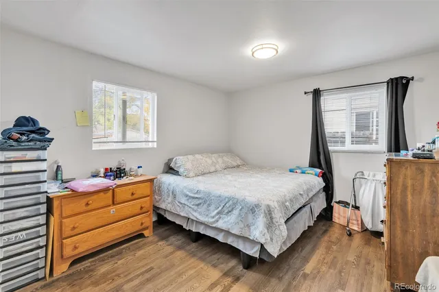 a bedroom with a bed and a flat tv screen on the dresser