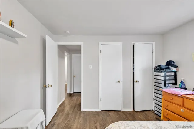 a view of a bedroom with wooden floor