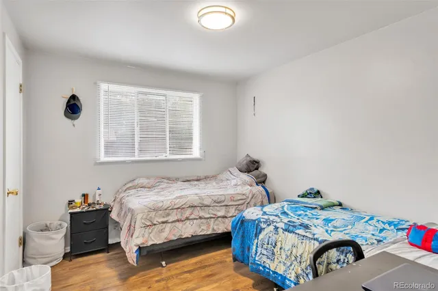 a bedroom with two beds and a window