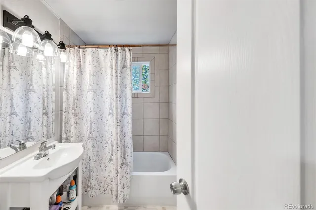 a bedroom with a bed next to a large window