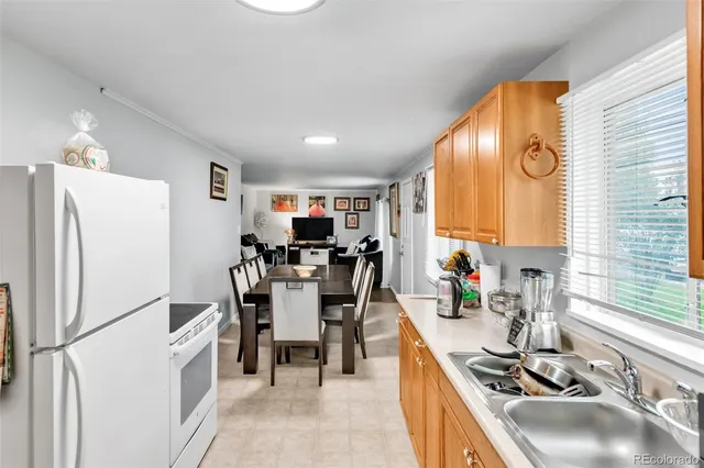 a kitchen with refrigerator and cabinets