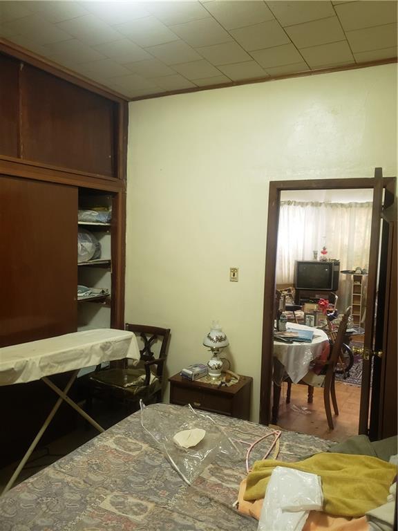 3022 Clarendon Road Brooklyn, NY 11226 - Photo 4 of 6 a bedroom with a bed and a mirror