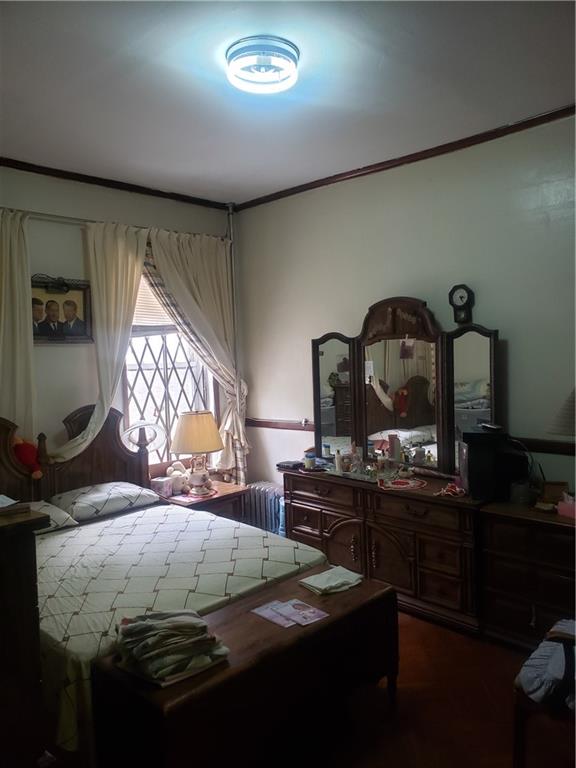3022 Clarendon Road Brooklyn, NY 11226 - Photo 5 of 6 a bedroom with a bed and a dresser