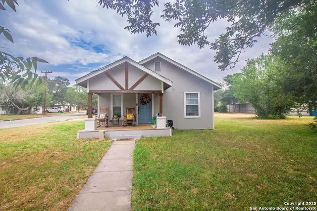 a front view of a house with swimming pool having outdoor seating