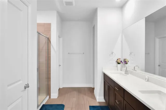 a bathroom with a double vanity sink and mirror