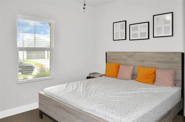 a bedroom with a bed and window