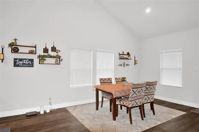 a view of a workspace with furniture and wooden floor