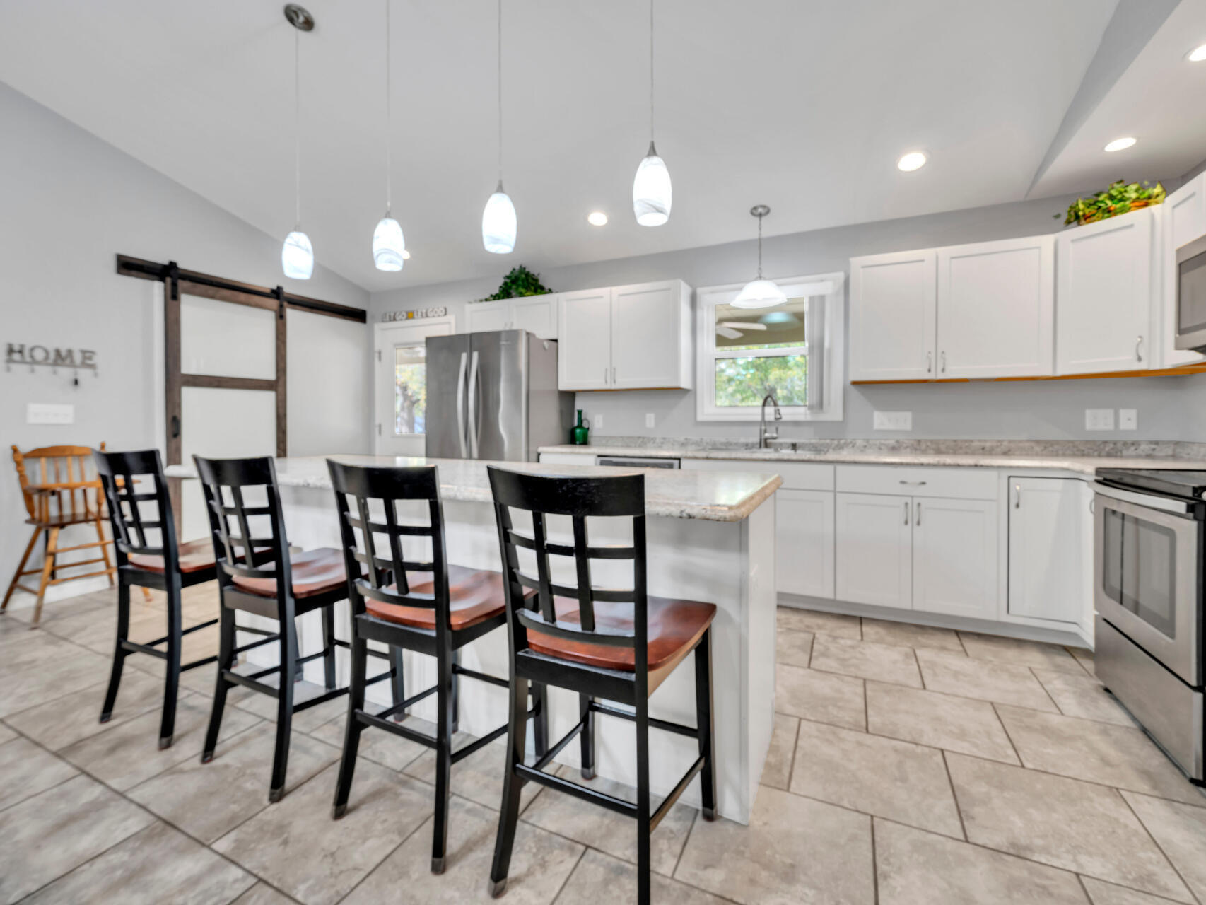 5346 Fox Hound Lane Baker, FL 32531 - Photo 12 of 46 a kitchen with cabinets and chairs in it