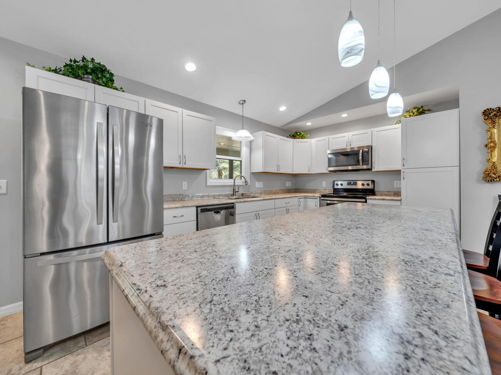 5346 Fox Hound Lane Baker, FL 32531 - Photo 15 of 46 a kitchen with stainless steel appliances granite countertop a refrigerator sink and cabinets